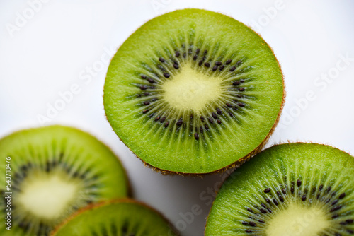 Green and juicy kiwi fruit close-up. Juicy tropical fruit kiwi macrophoto.