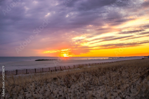 Vibrant sunset glow over a long peaceful beach. Long Beach, Long Island New York
