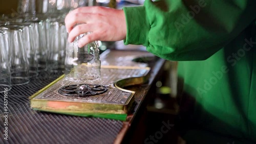 Bartender washes a glass in slow motion