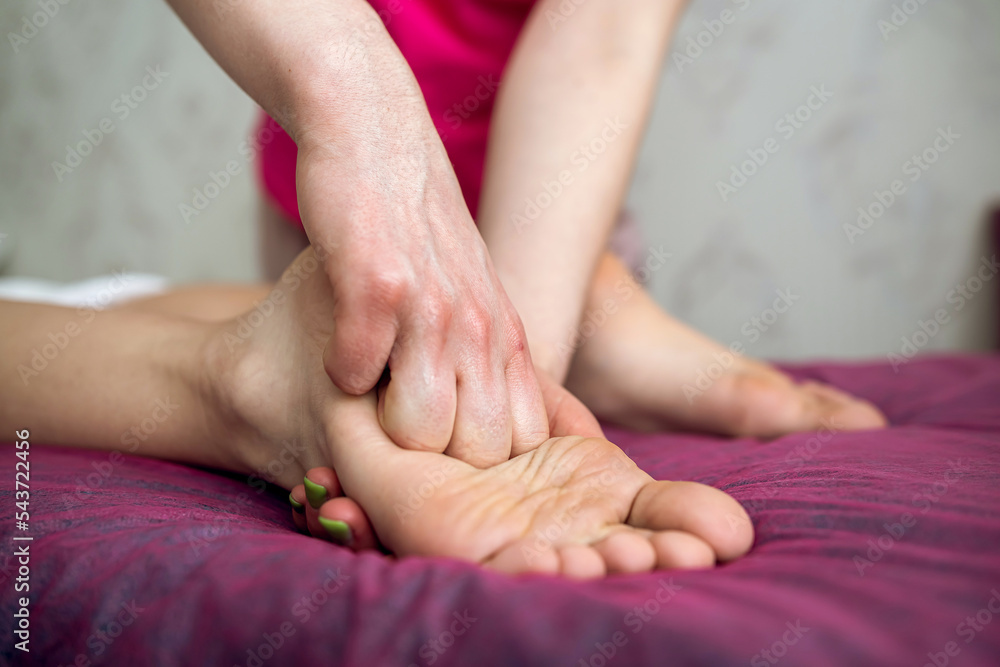 Detail of hands massaging client foot Detail of hands massaging client foot