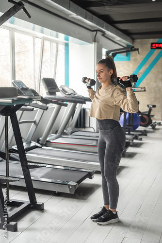 Fitness woman doing lunges exercises for leg muscles training training in the gym.