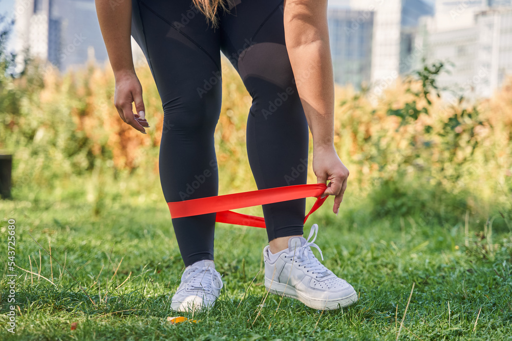 Close up view of the body positive female preparing making squats Close up view of the body positive female preparing making squats