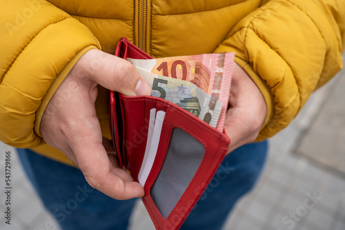 Hands hold wallet with money