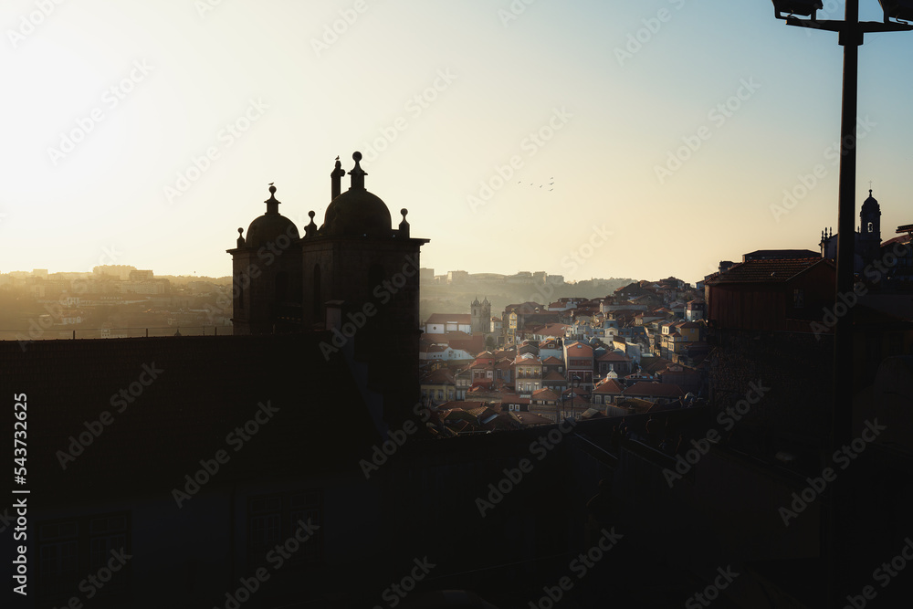 Fototapeta premium High angle view of Porto City at sunset with Igreja dos Grilos (Church of St. Lawrence) silhouette - Porto, Portugal