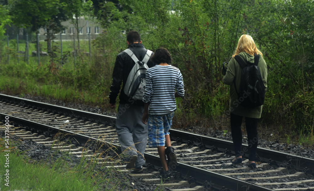 teenagers walking on railroad tracks teenagers walking on railroad tracks
