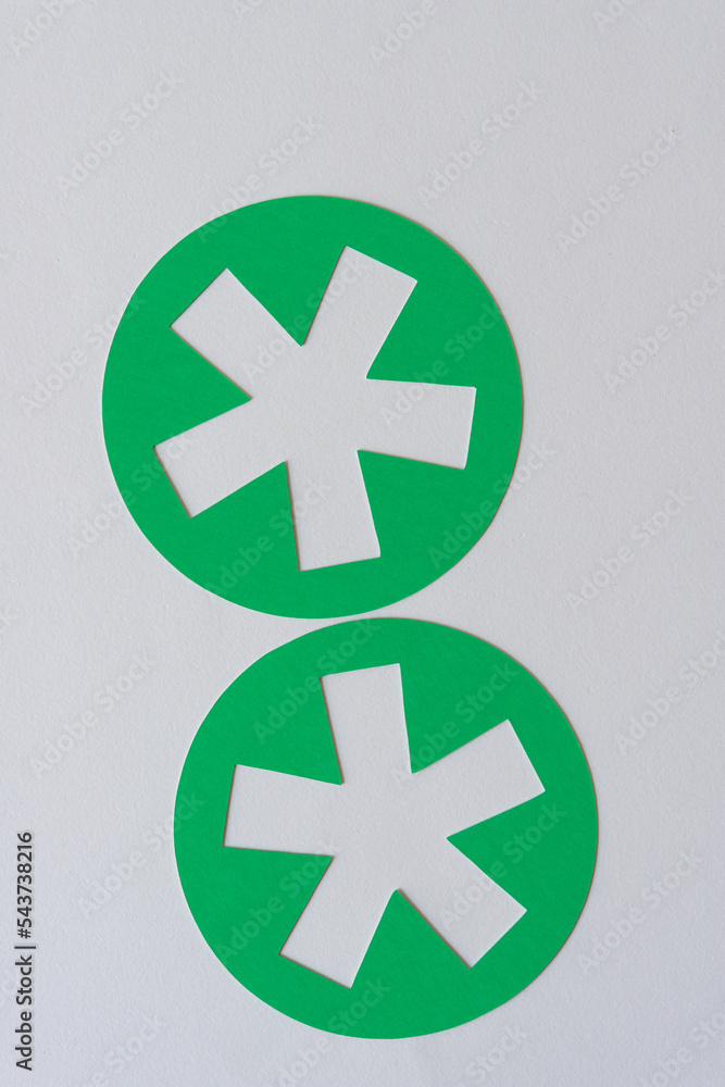 Obraz premium two green round shapes with asterisk cutouts