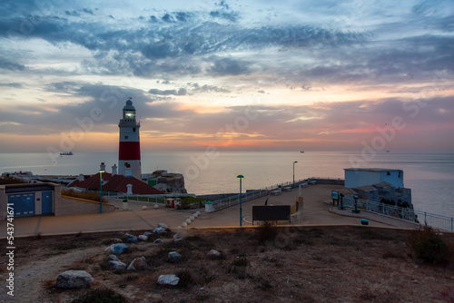 Europa Point Lighthouse with sea in background. Colorful Cloudy Sunrise Sky. Gibraltar, United Kingdom.