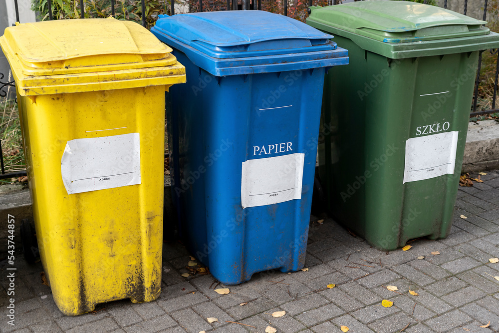 Black, blue, yellow, green garbage recycling bins on street in city. Separate waste, preserve the environment concept. Segregate waste, sorting garbage. Colored trash cans with paper, glass, plastic Black, blue, yellow, green garbage recycling bins on street in city. Separate waste, preserve the environment concept. Segregate waste, sorting garbage. Colored trash cans with paper, glass, plastic