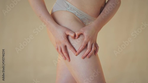 Wallpaper Mural Close up of natural woman in underwear making heart shape on thighs promoting body positivity - shot in slow motion Torontodigital.ca