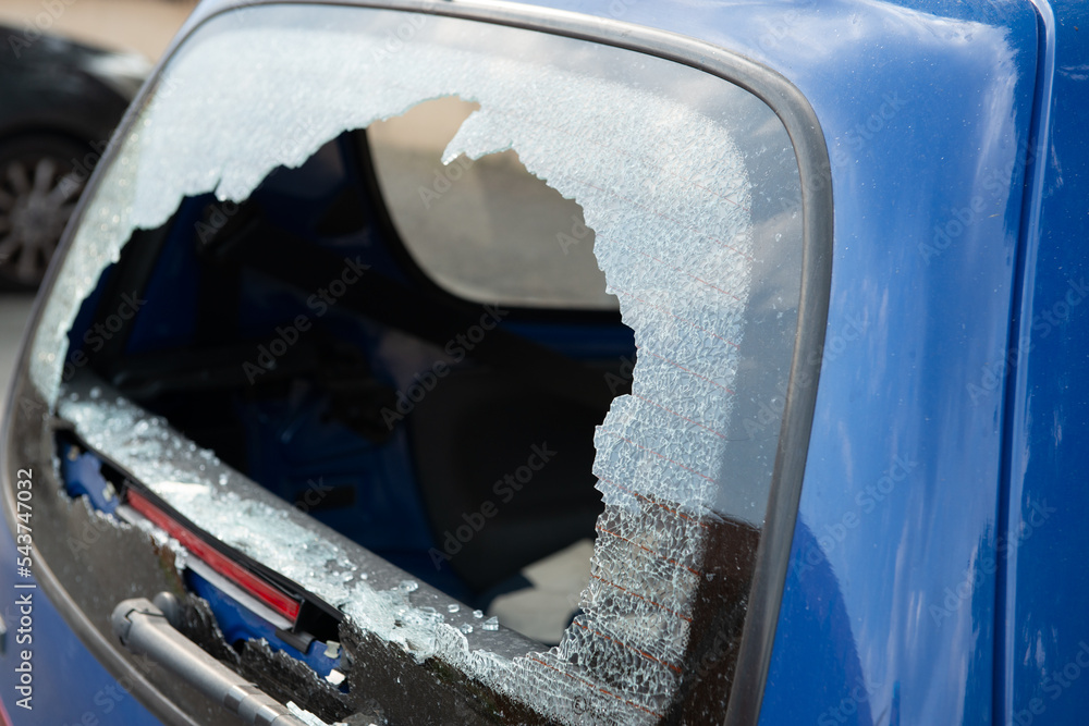 Rear window shattered in car parked in street parking. Thieves broke the glass in the automobile