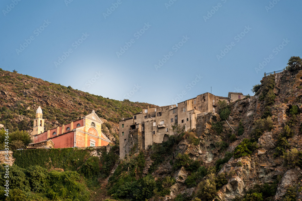 France. Corsica., Cap Corse. Nonza.  The Chuch of Santa Ghjulia (Sainte Julie) and the village clinging to the cliff