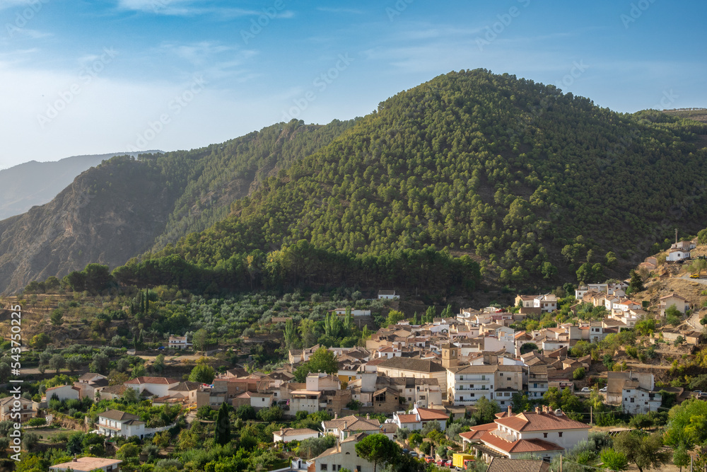 View of the Granada town of Cónchar (Spain) between mountains in the Lecrín Valley, a sunny autumn morning