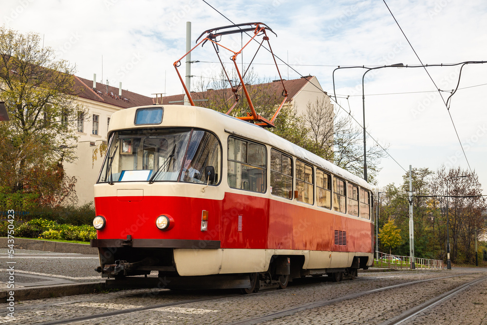 Old Tram on street of Prague in an autumn day, Czech Republic. Prague tram network is the third largest in the world. Development of passenger eco-friendly electric transport connection in the Europe 