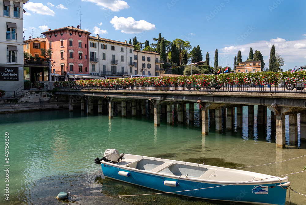 Beautiful cityscape with houses and boats at Canale di mezzo Peschiera, Lago di Garda, Italy