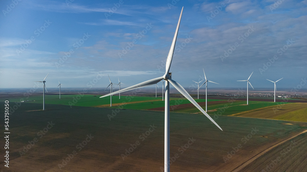 Wind turbines standing in the field from the drone point of view Wind turbines standing in the field from the drone point of view