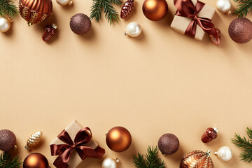 Vintage Christmas holiday greeting card template. Xmas frame made of gift boxes, bronze and brown baubles, fir branches, decorations on beige background