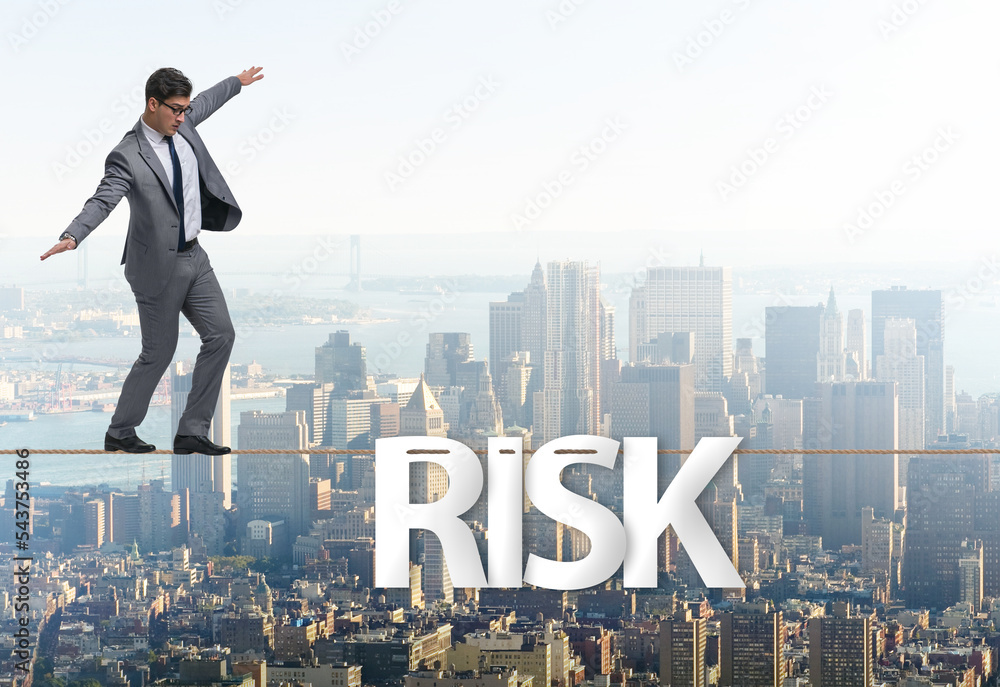 Businessman in risk concept walking on tight rope Businessman in risk concept walking on tight rope