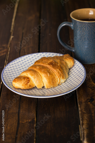 Fresh baked croissant with chocolate milk