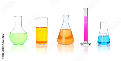 Set of different laboratory glassware with colorful liquids on white background. Banner design photo