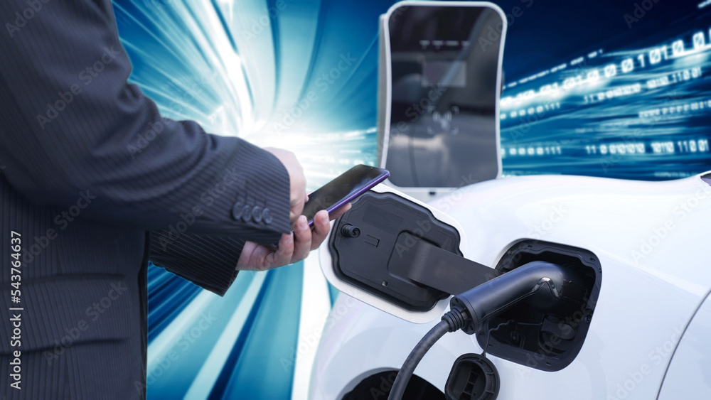 Progressive man charge electric car with power cable plug from charging ...