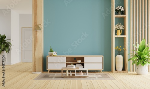 Cabinet for TV in modern living room on blue wall background.