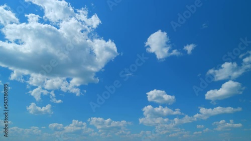 Puffy fluffy white clouds. Forming cloud moving with blue sunny, summer skies. Time lapse.