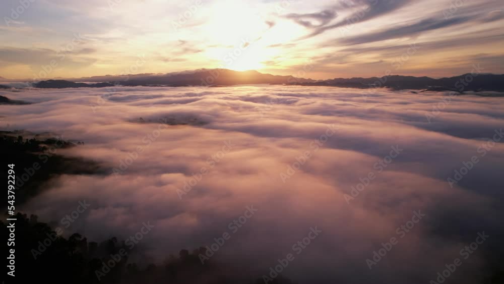 High angle view drone view of fog in rainy season over mountains,Beautiful sunrise sky clouds for create nature video scene. 4K High quality footage High angle view drone view of fog in rainy season over mountains,Beautiful sunrise sky clouds for create nature video scene. 4K High quality footage