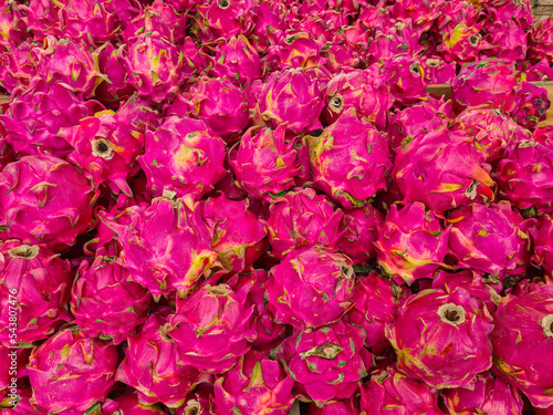 Dragon fruit, pitahaya, cactus, Pink bark, purple exotic tropical fruits fresh sell on market, tropical fruits texture, healthy organic food flat lay. Ripe tropical fruit close up. Asian fruit market