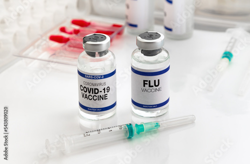 Fotografie Coronavirus vaccine and Flu vials vaccine for booster vaccination for new variants of Sars-cov-2 virus and Influenza A