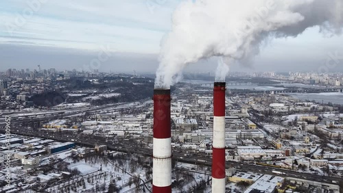 Aerial view of the heat power plant. Pipes with smoke and emissions into the atmosphere. Ecology and greenhouse effect.