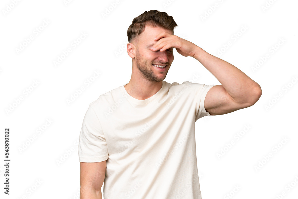 Young blonde caucasian man over isolated background smiling a lot