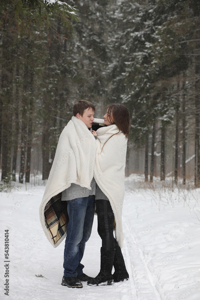 pair of lovers on a date winter afternoon in a snow blizzard pair of lovers on a date winter afternoon in a snow blizzard