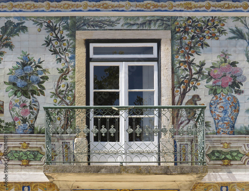 Streets of Lisbon. Traditional tiled facade decorated by tiles with colorful flowers, plants and animals. Portugal. 