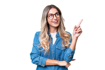 Young Uruguayan woman over isolated background pointing up a great idea