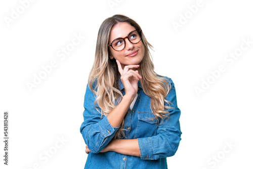 Young Uruguayan woman over isolated background thinking an idea while looking up