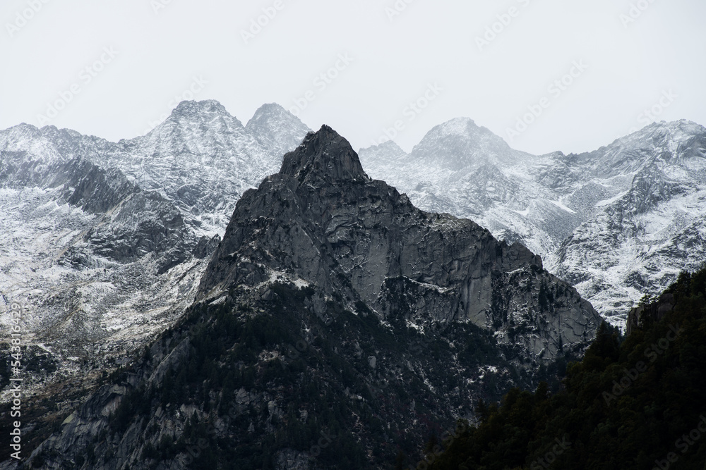 Snow covered peaks of the mountains that surround the area of Val di Mello, in the Masino Valley, Northern Italy 