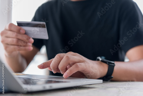 Online shopping e-commerce or internet banking concept.Man hand holding credit card and using laptop.Business finance payment and accounting. © khunkornStudio