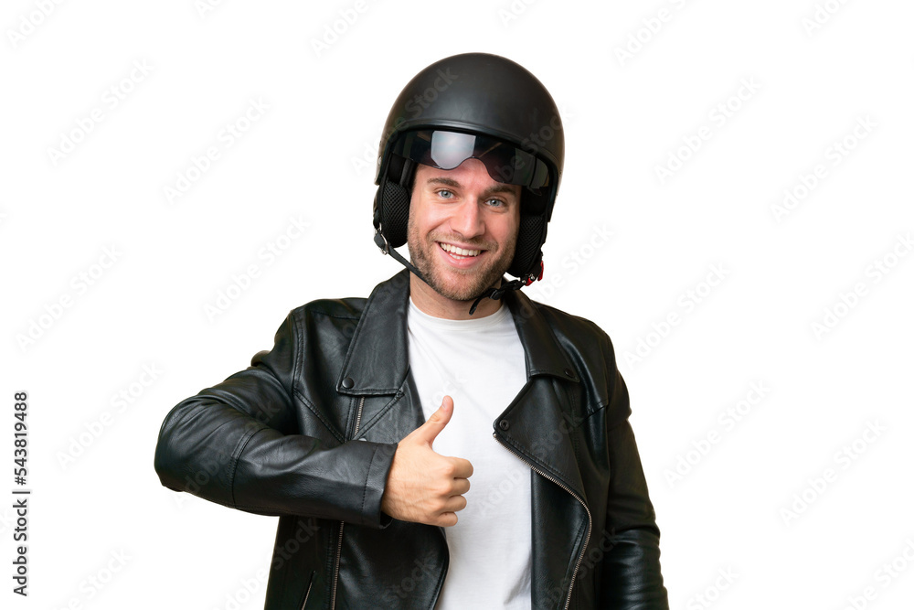 Young caucasian man with a motorcycle helmet isolated on green chroma background giving a thumbs up gesture Young caucasian man with a motorcycle helmet isolated on green chroma background giving a thumbs up gesture
