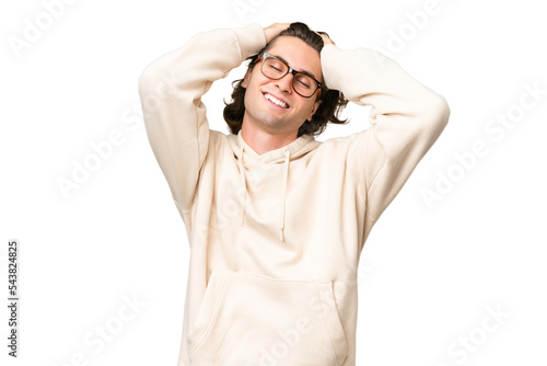 Young caucasian man isolated on green chroma background laughing