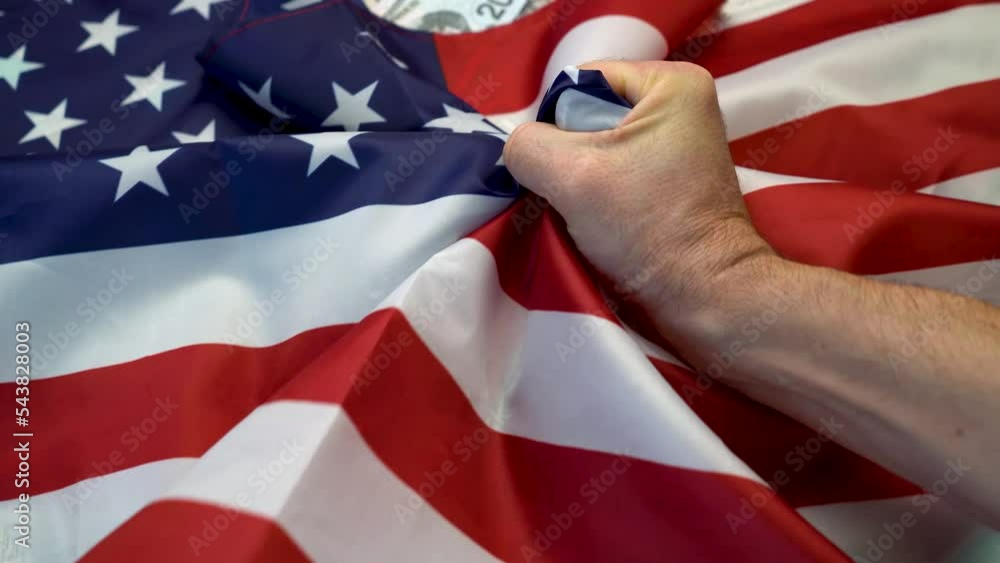 Fist Raising American Flag Uncovering Many Dollars Close up Of An fist-raising-american-flag-uncovering-many-dollars-close-up-of-an