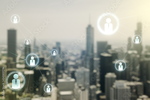 Double exposure of abstract virtual social network icons on blurry cityscape background. Marketing and promotion concept