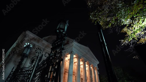 Romanian Atheneum in Bucharest. Night landscape under the full moon with this iconic landmark from Romania. Long exposure 4k video. photo