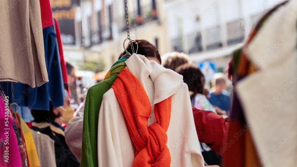 Girl looking at clothes in a flea market. The flea market. Madrid