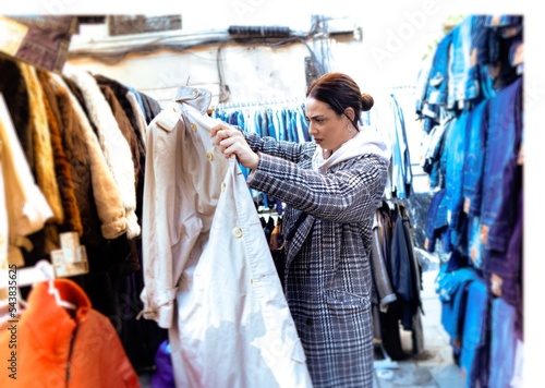 Girl looking at clothes in a flea market. The flea market. Madrid photo