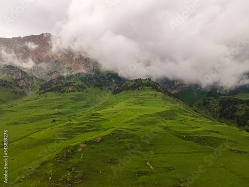 Amazing mountain landscape. Beautiful clouds, fields, mountains. Aerial view