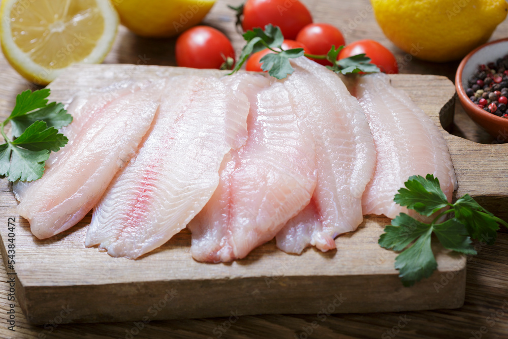 fresh fish fillet of tilapia with ingredients for cooking fresh fish fillet of tilapia with ingredients for cooking