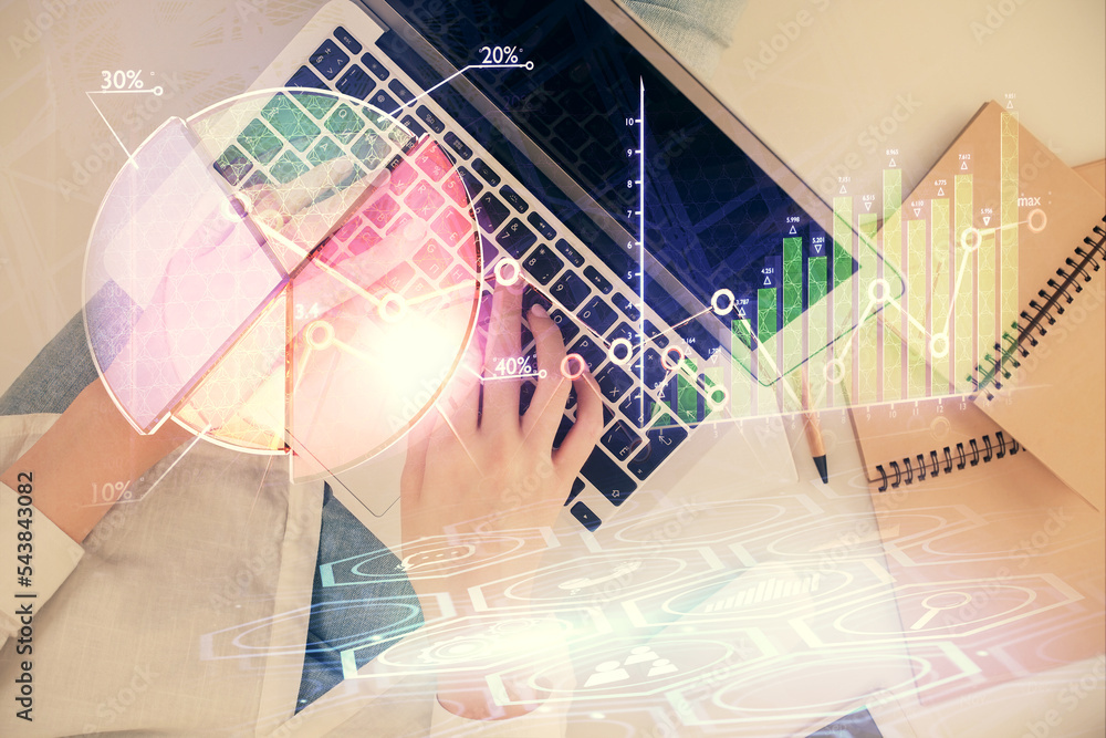 Double exposure of woman hands working on computer and forex graph hologram drawing. Top View. Financial analysis concept. Double exposure of woman hands working on computer and forex graph hologram drawing. Top View. Financial analysis concept.