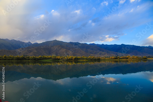 Lake in the mountains. Beautiful nature, reflection of clouds and mountains in blue water. Kyrgyzstan, Lake Issyk-Kul