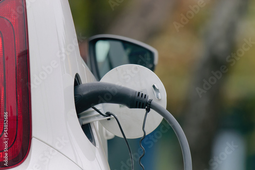 Close-up photo of an electric vehicle charging at a charging station  © Eleseus