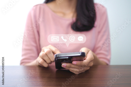 Contact us or contact customer support. Businessman using phone contact icon on virtual screen (email, address, chat)